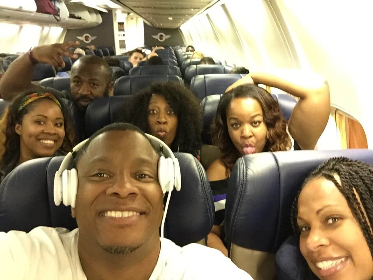 A group of people sitting on top of an airplane.